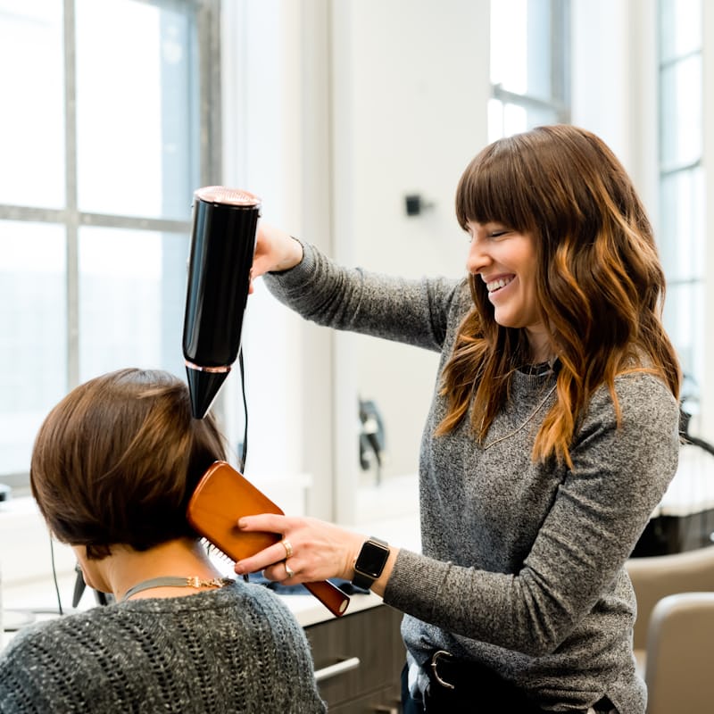 Stylist blow-drying a fresh cut